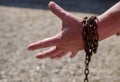 Caucasian man hand in rusty chains