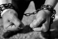 Caucasian man hand in rusty chains , shallow depth of field, conceptual image of  crime Royalty Free Stock Photo