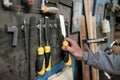 Caucasian man hand taking a chisel for wood working. Royalty Free Stock Photo