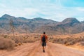 Caucasian man hiker in the middle of a desert trail in the natural park of Cabo de Gata, Spain