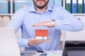 Caucasian man holding a small house on his hands - the concept of real estate Royalty Free Stock Photo