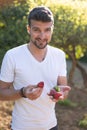 Caucasian man holding strawberries in garden