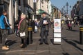 Caucasian man holds a copy of WatchTower for the Jehovah`s Witnesses on the street. Street preaching, missionary, Christianity