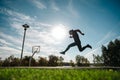 Caucasian man jumping with high hip raise outdoors.