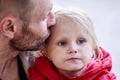 Caucasian man kisses baby daughter in forehead. Royalty Free Stock Photo