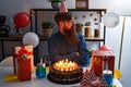 Caucasian man with long beard celebrating birthday holding big chocolate cake looking to side, relax profile pose with natural Royalty Free Stock Photo