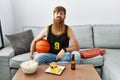 Caucasian man with long beard holding basketball ball cheering tv game looking at the camera blowing a kiss on air being lovely Royalty Free Stock Photo