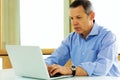 Caucasian man looking at his laptop computer Royalty Free Stock Photo