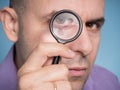 Caucasian man looking magnifying glass