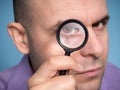 Caucasian man looking magnifying glass