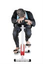 Caucasian man looks tired on a spin bike Royalty Free Stock Photo