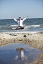 Caucasian man in lotos pose levitates above the beach