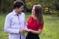 Caucasian man in love down proposing to his beloved girlfriend, putting the ring on her finger