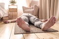 Caucasian man meditating on a wooden floor and lying in Shavasana pose Royalty Free Stock Photo