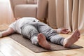 Caucasian man meditating on a wooden floor and lying in Shavasana pose Royalty Free Stock Photo