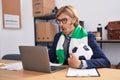 Caucasian man with mustache working at the office supporting football team scared and amazed with open mouth for surprise, Royalty Free Stock Photo