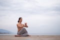 Caucasian man with naked torso practicing wushu on the seashore. Royalty Free Stock Photo