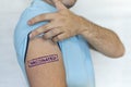 Caucasian man, patient with blue stamp vaccinated on hand. Concept of people vaccination for covid-19 coronavirus, flu, infectious Royalty Free Stock Photo