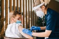 Caucasian man patient getting vaccinated against coronavirus receiving covid vaccine. Intramuscular injection during doctor`s