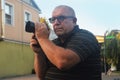 Caucasian man photographer with a modern camera on a city street. The shooting process Royalty Free Stock Photo