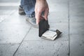 Caucasian man picking up a lost wallet in a city Royalty Free Stock Photo