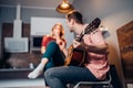 Caucasian man playing guitar for young girl at home Royalty Free Stock Photo