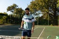 Caucasian man playing tennis bouncing ball on racket on outdoor tennis court Royalty Free Stock Photo