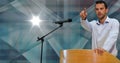 Caucasian man on a podium pointing in a direction against copy space on blue background