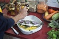 Caucasian man preparing a whole fish in a white oven dish, delicious and healthy food Royalty Free Stock Photo