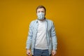 Man in a protective medical mask, he is very afraid of contracting the virus, clenched fists and looks in camera in Royalty Free Stock Photo