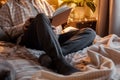 A caucasian man relaxing at home, reading a book in bed Royalty Free Stock Photo