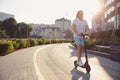 Caucasian man riding electric scooter against cityscape Royalty Free Stock Photo