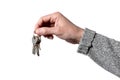 Caucasian man`s hand holding keys isolated on white background with clipping path Royalty Free Stock Photo