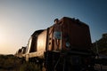 Caucasian man standing in front of a vintage train, gazing out at the picturesque ocean landscape Royalty Free Stock Photo