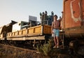 Caucasian man standing in front of a vintage train, gazing out at the picturesque ocean landscape Royalty Free Stock Photo