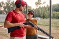 caucasian man teach woman to recharge a rifle on shooting range outdoors Royalty Free Stock Photo