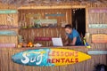 Caucasian man using his laptop on a beach