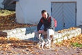 Caucasian man walking with jack russell terrier dog in autumnal park