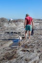 Caucasian Man walking with Jack Russell Terrier dog playing on the beach Royalty Free Stock Photo