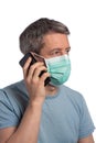 Caucasian man wearing a protection and making a phone call with a cell phone mask on a white background