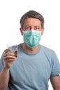 Caucasian man wearing a protection mask with a glass of water on a white background