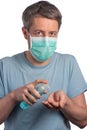 Caucasian man wearing a protection mask using hand sanitizer on a white background