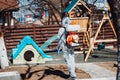 man wearing protective hazmat suit spraying disinfectant and chemicals. Decontamination. Protection and prevention amid Royalty Free Stock Photo