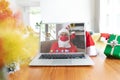 Caucasian man wearing santa claus costume having christmas video call on laptop screen Royalty Free Stock Photo