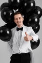 caucasian man in white suit tuxedo with black air balloons Royalty Free Stock Photo