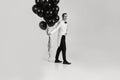 caucasian man in white suit tuxedo with black air balloons Royalty Free Stock Photo