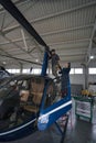 Caucasian man and woman mechanic in uniform inspecting plane engine in hangar Royalty Free Stock Photo