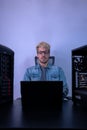 Caucasian man working with programming in dark background. Hacker, engineer, program developer concept