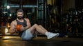 Caucasian man workout in gym doing seated oblique twist exercise with weight medicine ball on floor which strengthen the abs Royalty Free Stock Photo