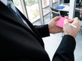 Caucasian manager man writing ideas on sticky note pink color close up hand use pencil with office background Royalty Free Stock Photo